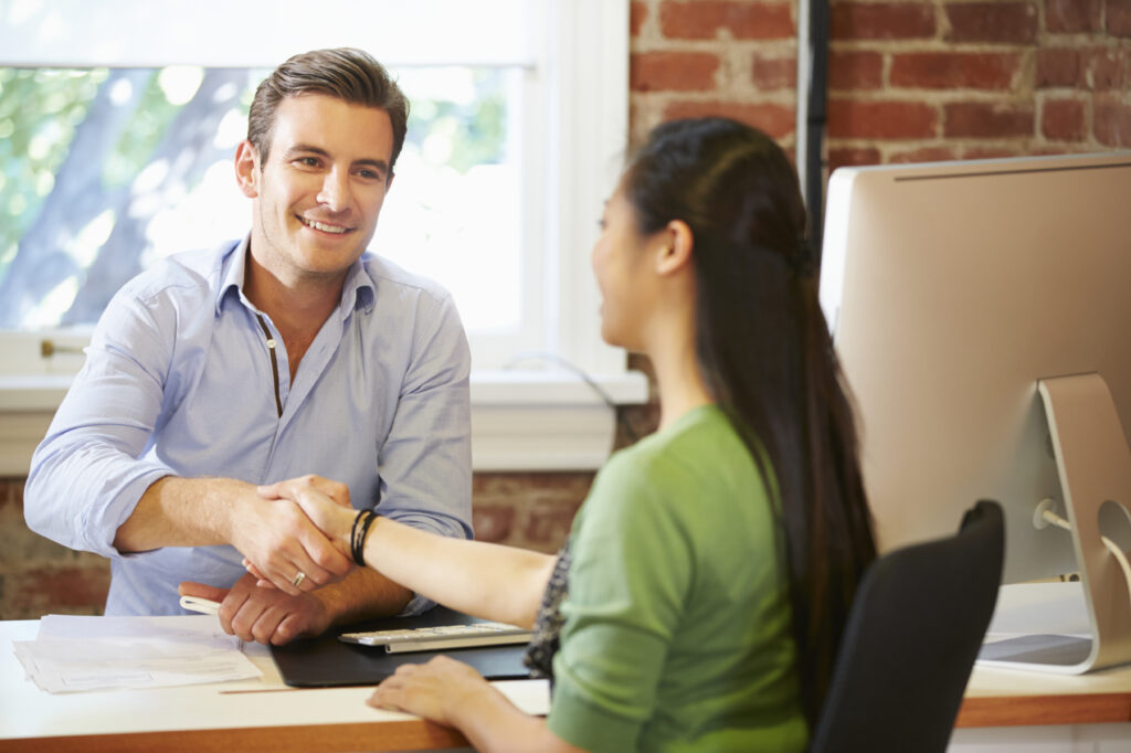 Businessman Interviewing Female Job Applicant In Office